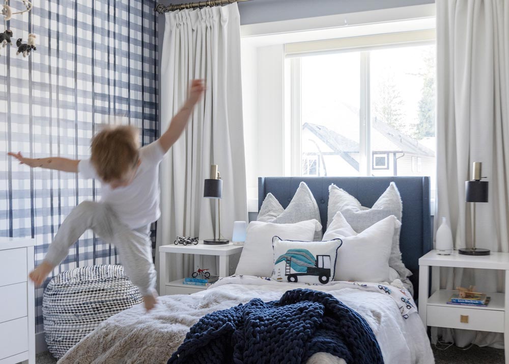 little boy in room with truck blue decor
