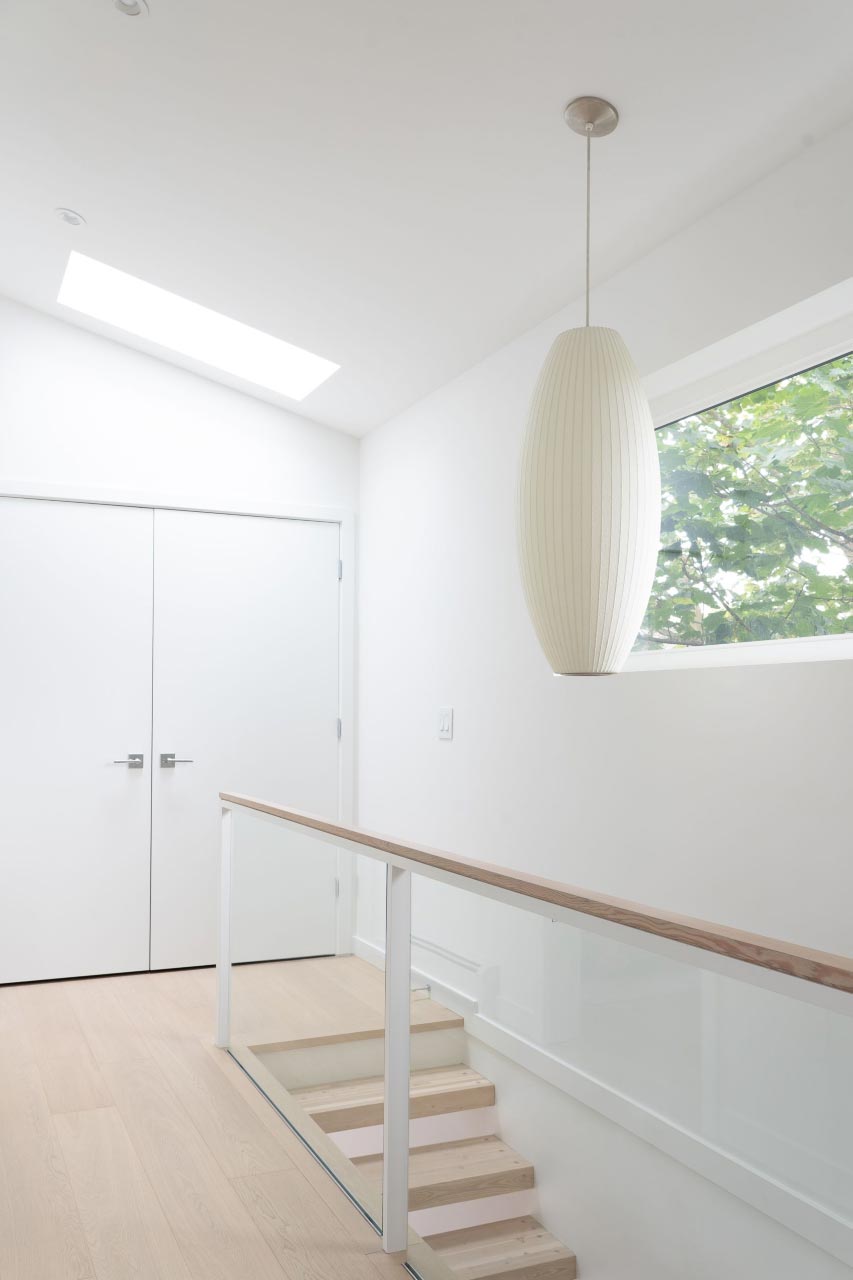 minimalist light fixture over stairs
